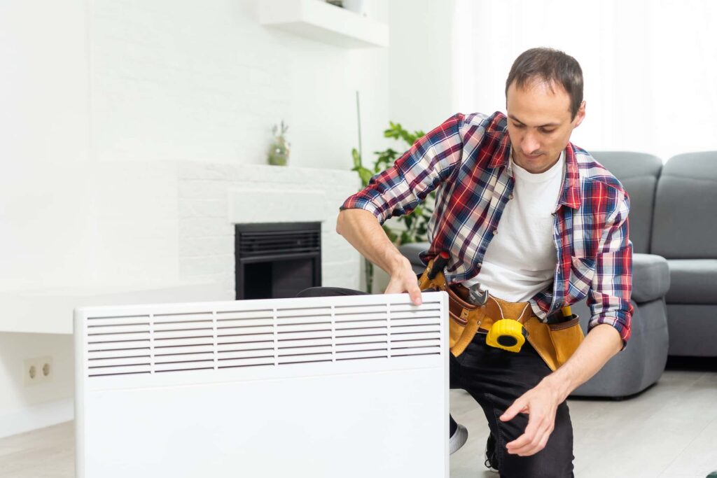 Electrician testing a storage heater heating element